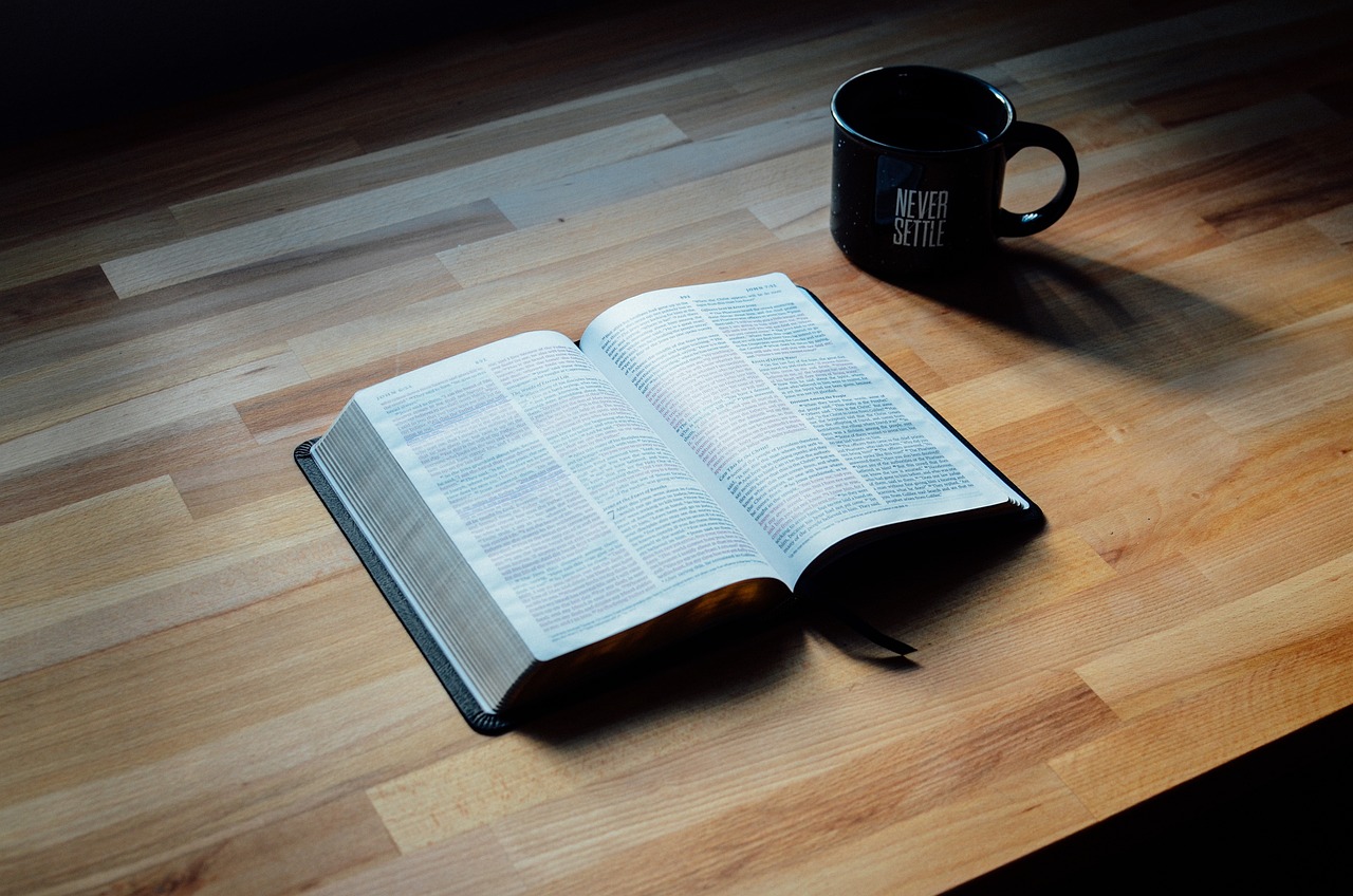 Let God’s Word soak in - open Bible glowing in light .
