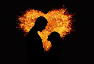 man and woman silhouette  against a glowing heart representing new heart and new spirit