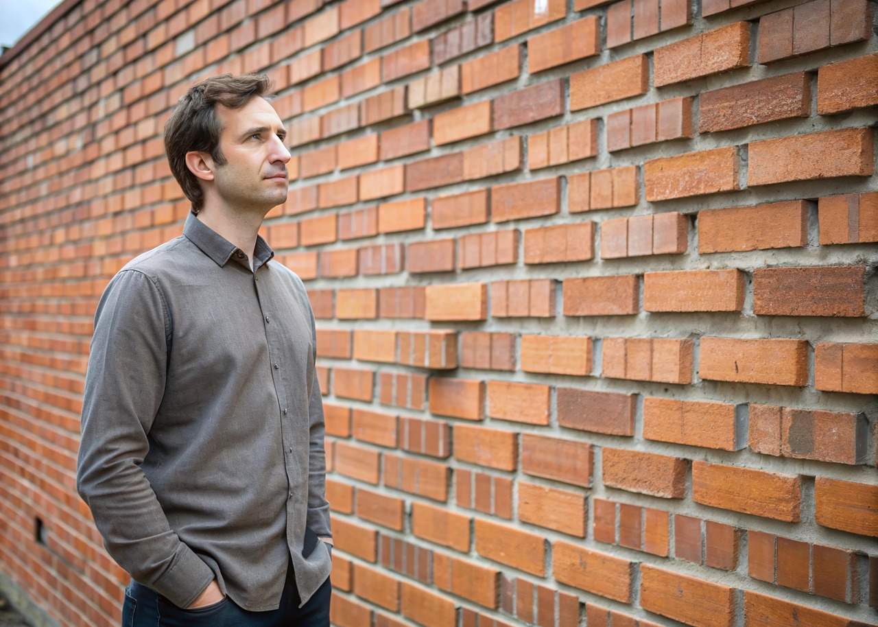 Builder of the Kingdom - A Man admiring bricks laid in light symbolizing builder of the Kingdom