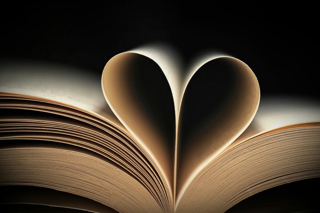 Open Bible with heart-shaped light symbolizing God’s Word stored in the heart