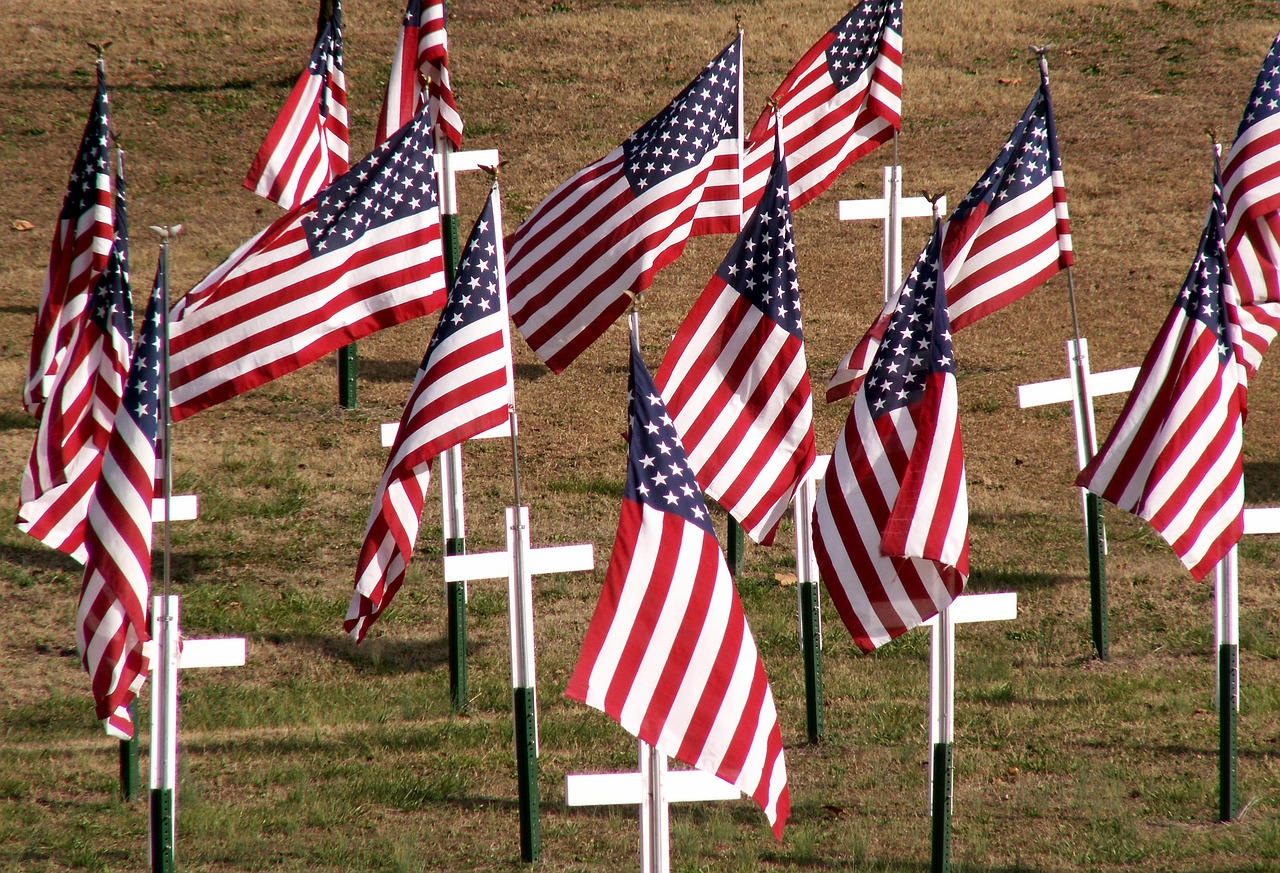 An American flag at sunrise with a glowing cross, symbolizing Memorial Day hope for Christians.