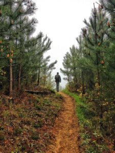 Man walking alone on a rugged path symbolizing life's tests of faith