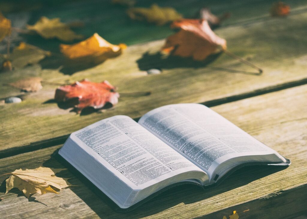Open Bible beside a Thanksgiving table with autumn colors
