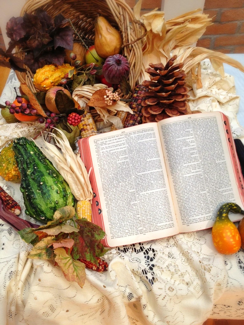 Bible open with autumn leaves representing thanksgiving to God.
