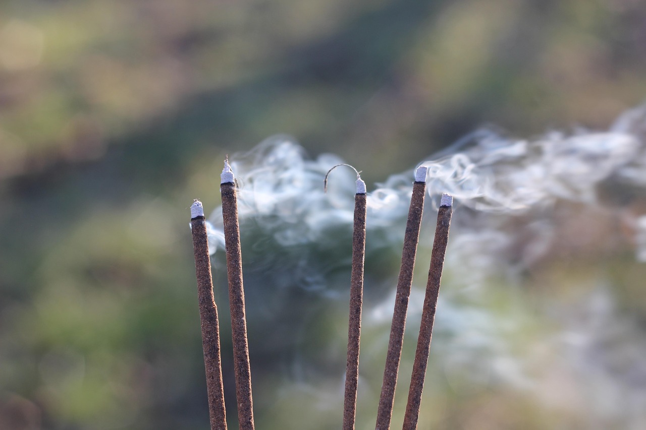 Incense smoke rising in soft light symbolizing prayer ascending to God