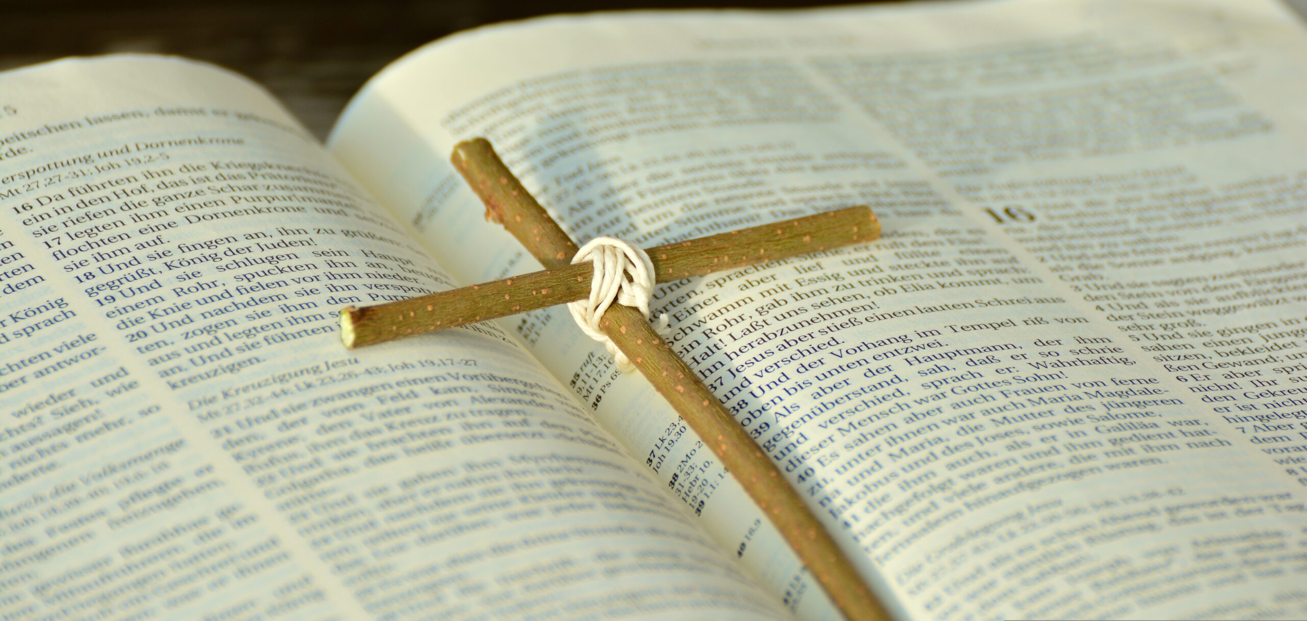 Open Bible and cross with light symbolizing salvation by grace through faith