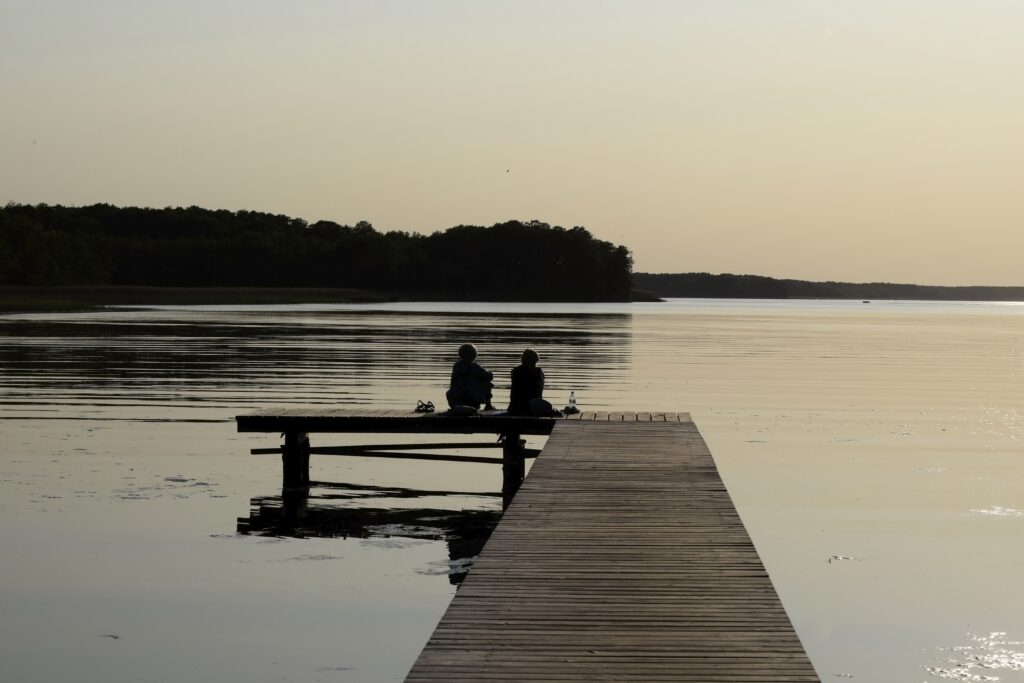 Peaceful sunrise over still waters representing God’s calming presence