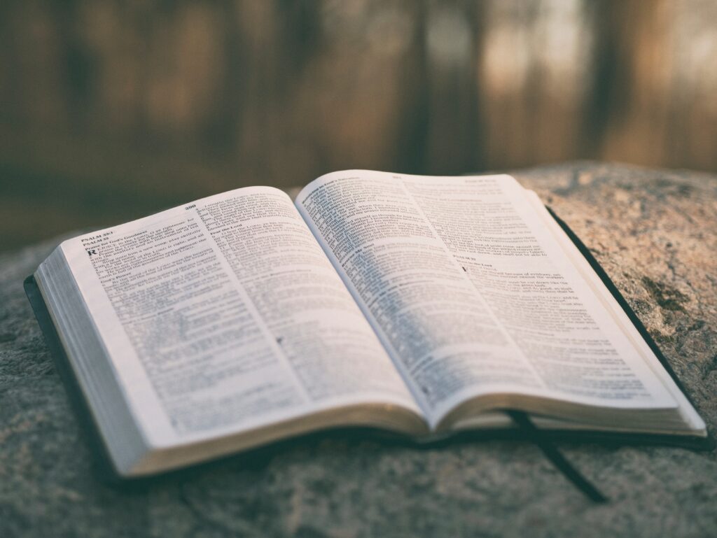 Open Bible resting on a rock symbolizing God's truth as life's foundation.