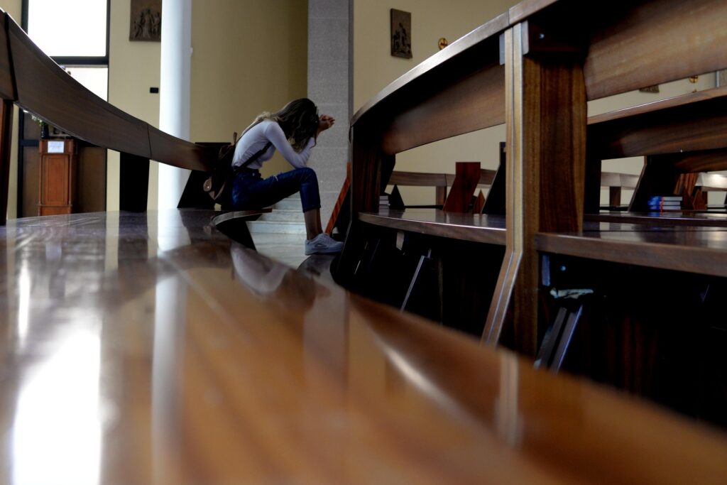 Worshipper praising God in faith during difficult circumstances.