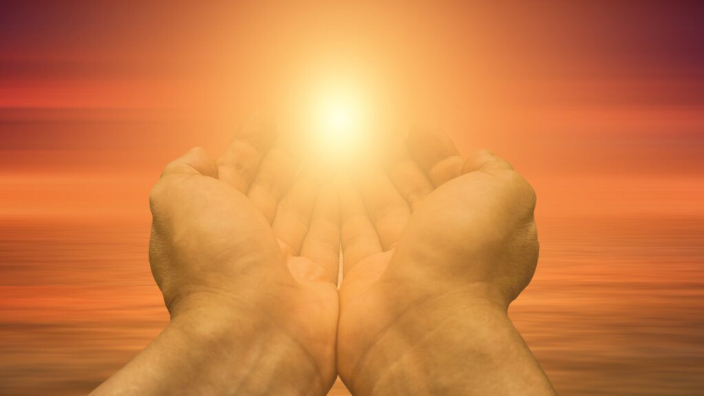 Open hands holding a glowing light symbolizing God's spiritual gifts and faithful stewardship.