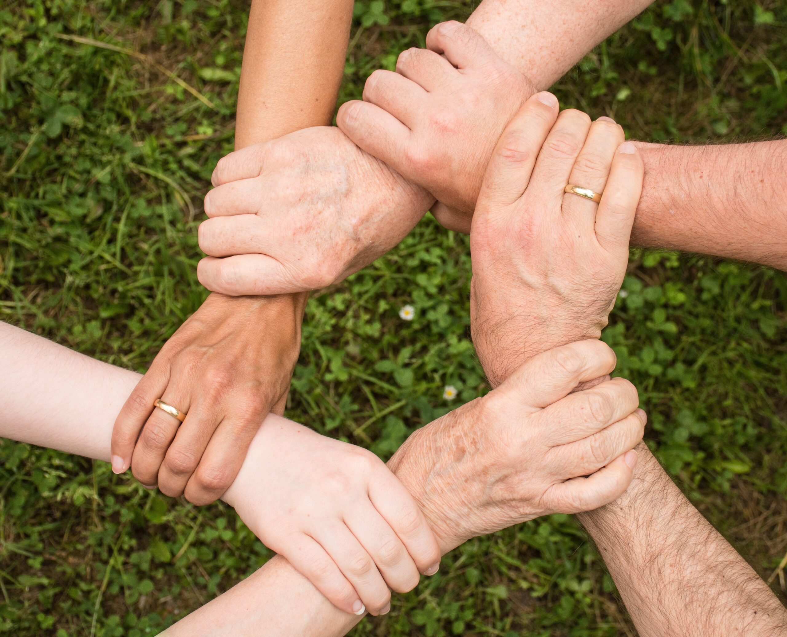 Diverse group of hands joined together representing unity in the body of Christ