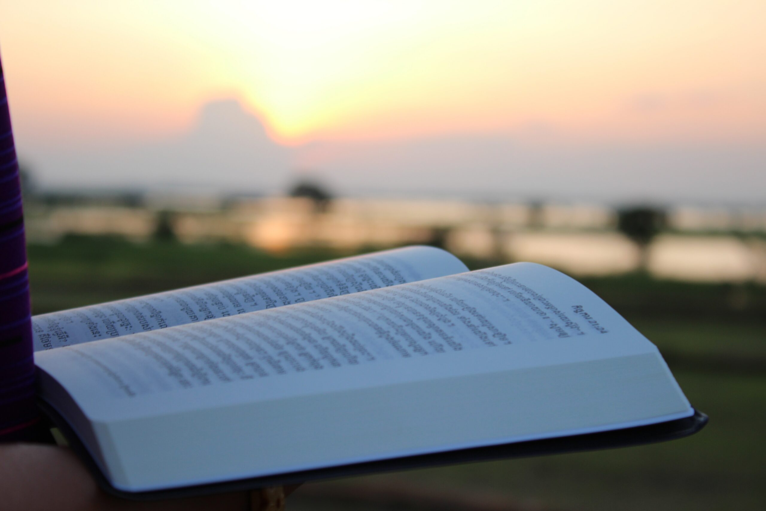 Open Bible with a sunrise symbolizing God's faithfulness and a believer's daily commitment to faithful obedience.