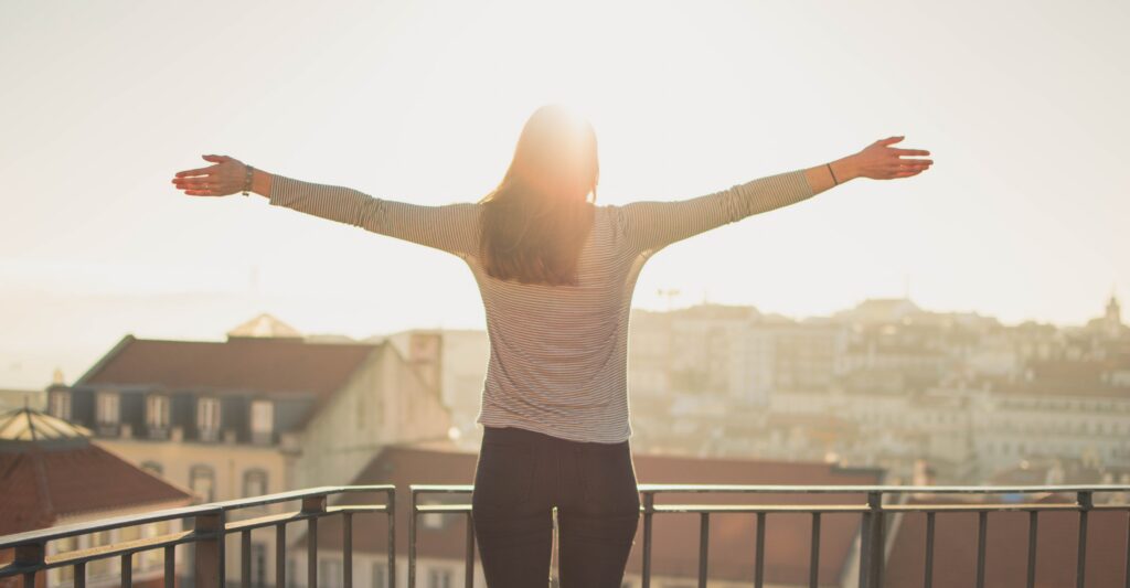 Person standing confidently in morning light, representing identity and belonging in Christ