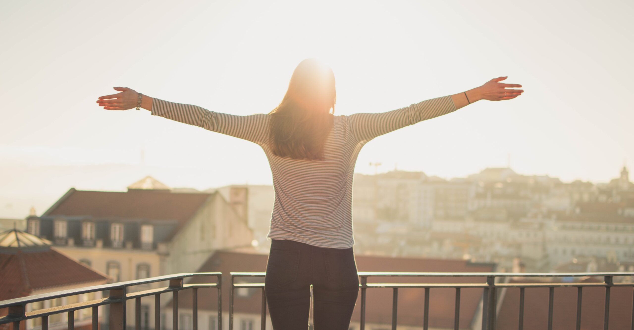 Person standing confidently in morning light, representing identity and belonging in Christ
