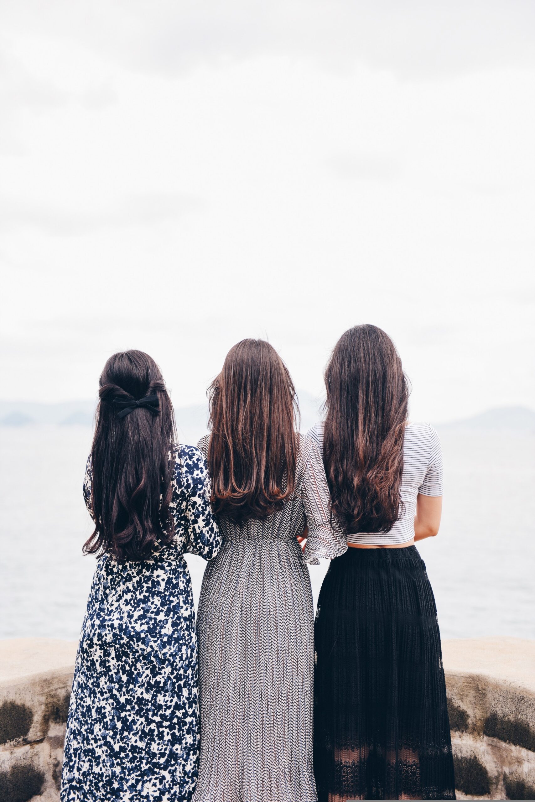 Three friends praying together outdoors, symbolizing a trusted Christian inner circle