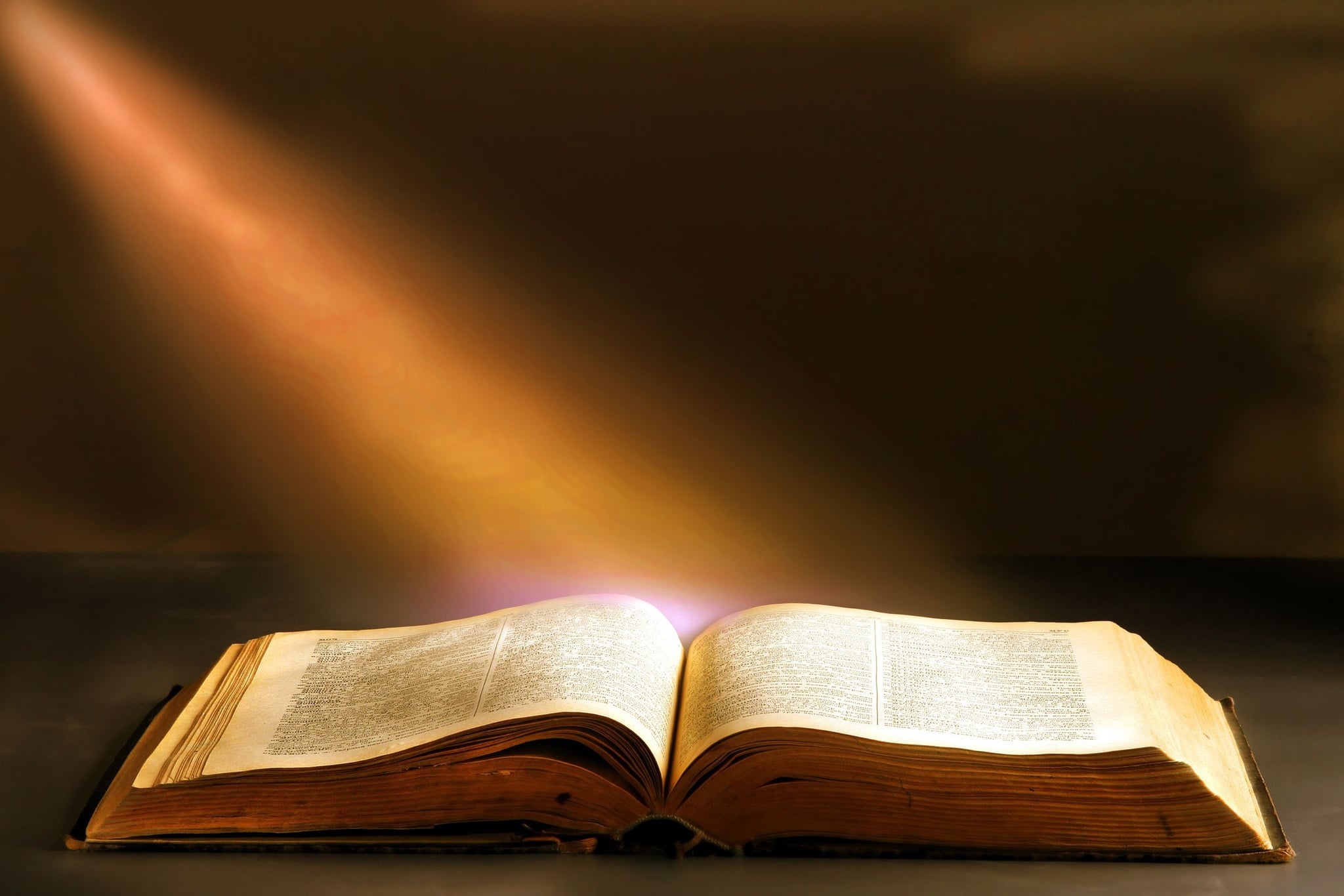 Open Bible with sunlight representing Christ living within the believer