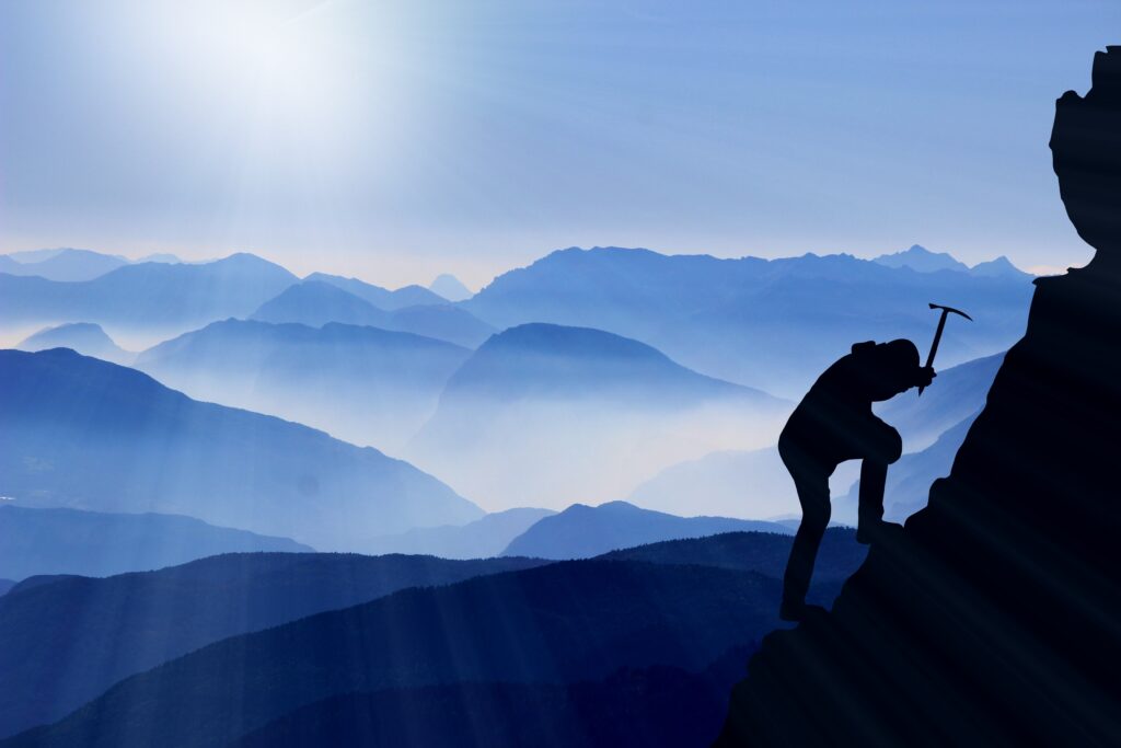 Sunrise breaking over a rugged mountain trail, symbolizing how suffering produces endurance and leads to hope in Christ