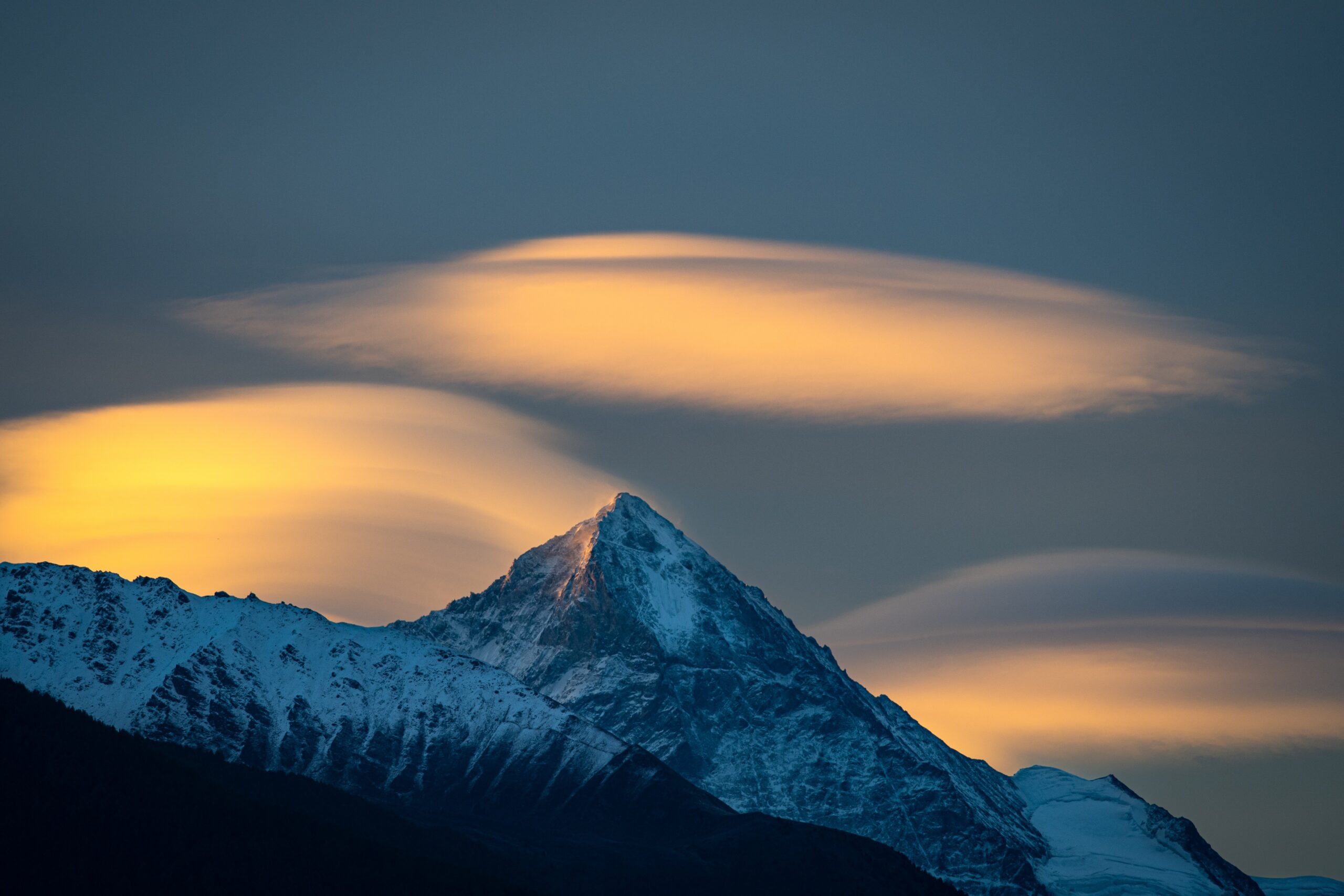 Sunrise breaking over a mountain summit, a picture of the victory believers already have in Christ