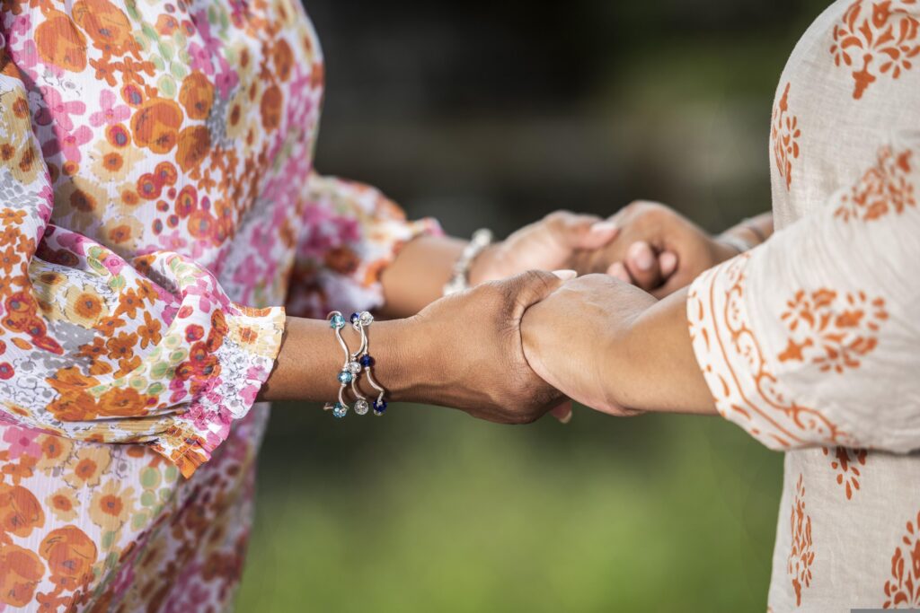 One hand gently holding another in comfort, a picture of how we pass on God's comfort to those who are hurting