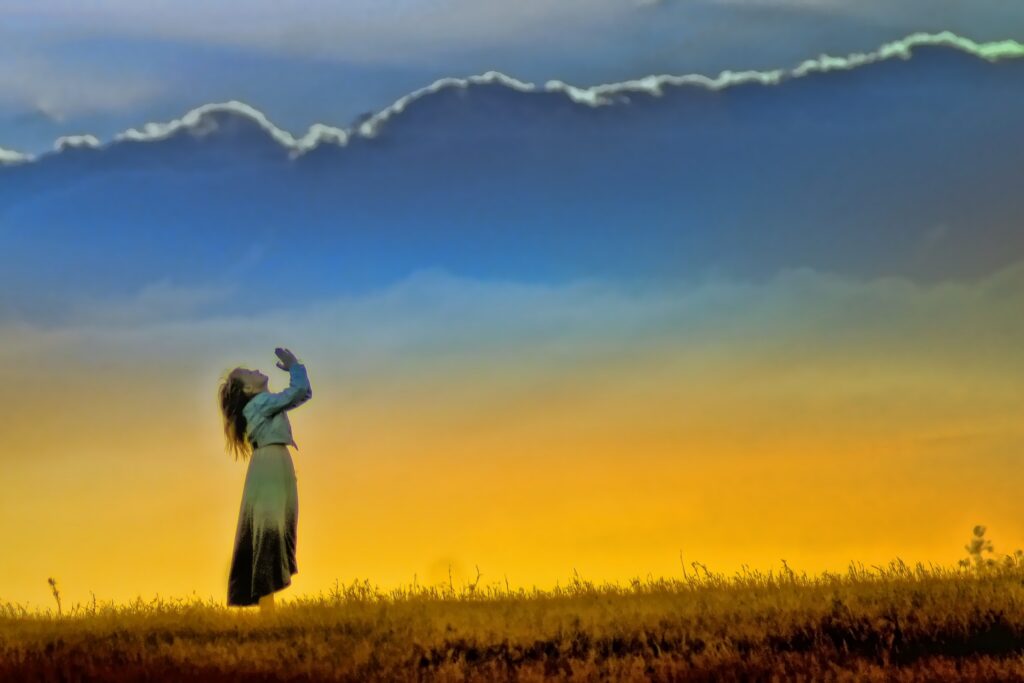Hands lifted in worship at sunrise, a picture of a heart that gives thanks in all circumstances
